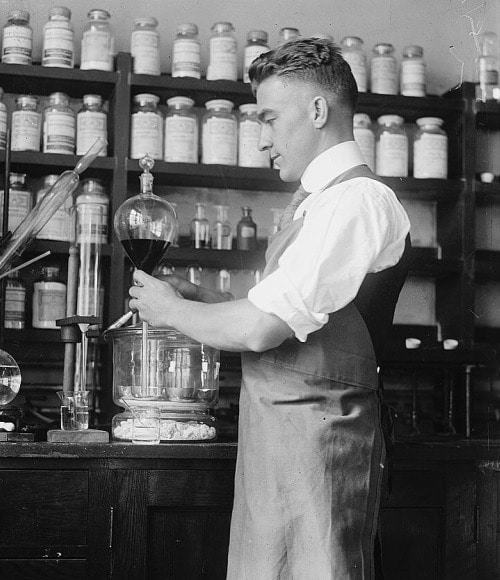 Vintage doctor researcher working with blood in lab.