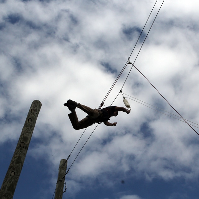 Man doing ropes course.