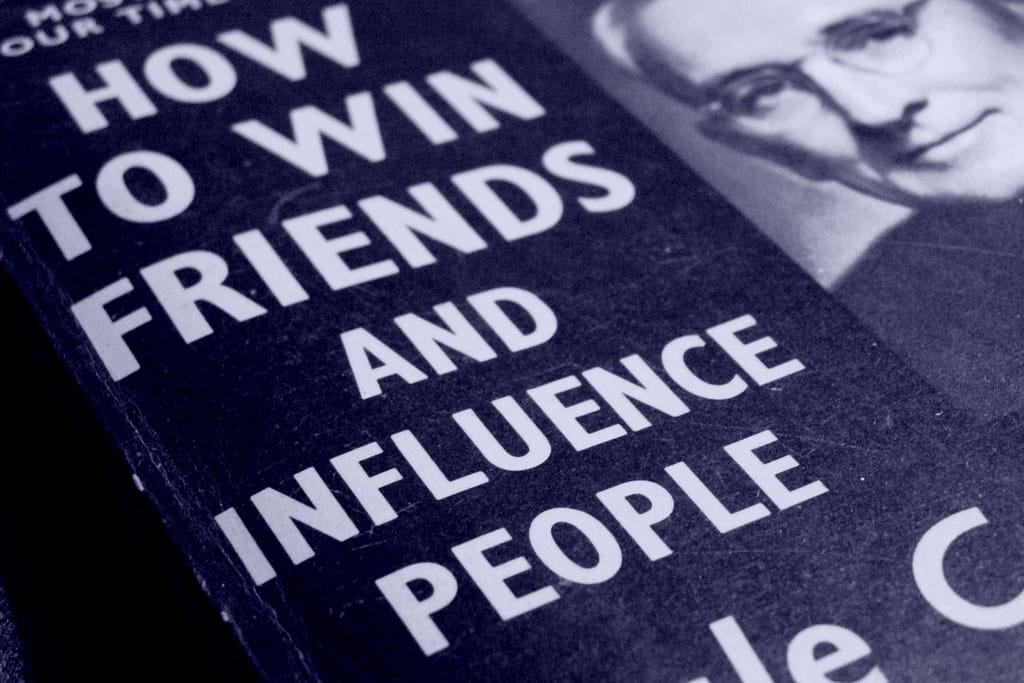 Close-up of the book "how to win friends and influence people in the 21st century" by Dale Carnegie.