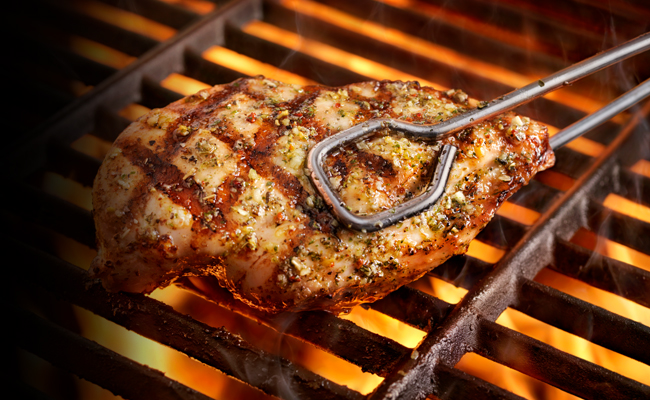 Chicken breasts are grilling to perfection on the grill.