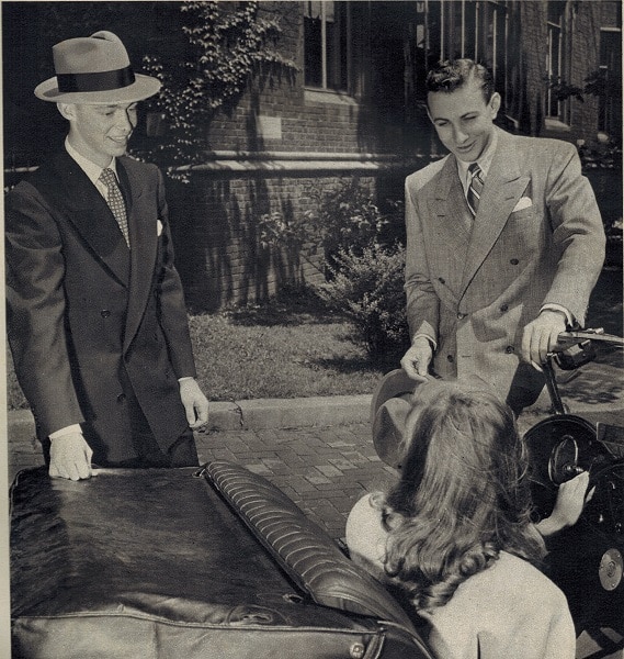 Vintage college men talking with woman in car. 