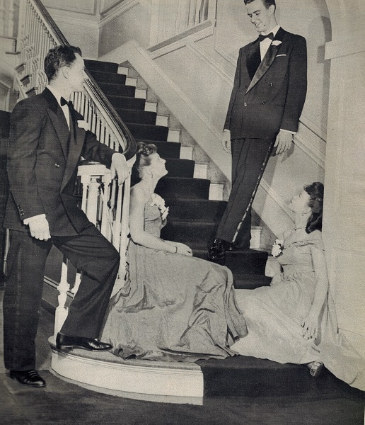 Vintage couples talk each others at home stairs.