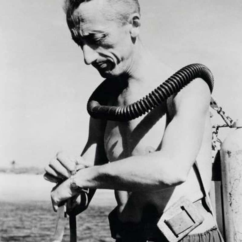 Vintage Jean Jacques Cousteau getting ready to dive into water.