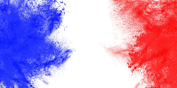 Blue and red powder explosion on a white background, symbolizing the theme of "Overdoing Democracy" discussed in Podcast #847.