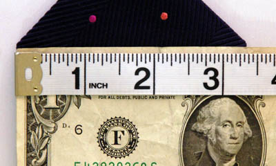 A width of dollar note measuring in inches.