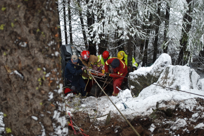 A group of rescuers from a search and rescue team in a snowy area.