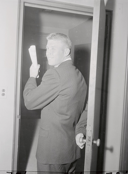 Gentleman seeing off while holding a piece of paper. 