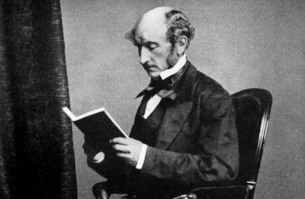 A man reading a book in a chair.