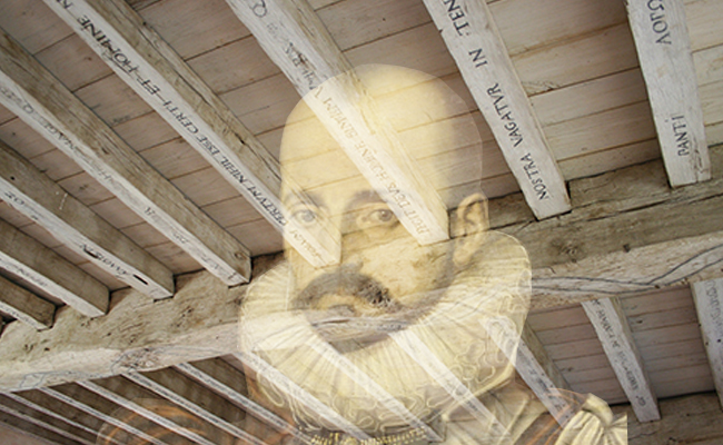 An image of a man with a beard under a wooden ceiling, reflecting on life and the words of Michel de Montaigne.