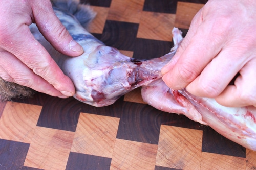 Man cutting off the rabbit head.