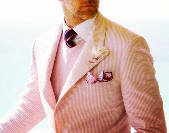 Man wearing pink seersucker suit. 