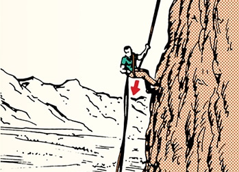 Climber performing an emergency rappel down a rock face using a rope, with mountains in the background.