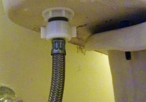 Attach the supply hose to the bottom of the tank.