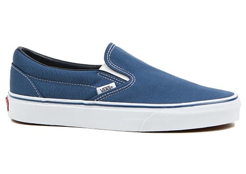 A blue Vans slip-on sneaker with white stitching, a white rubber sole, and a small Vans logo tag on the side—perfect men's summer footwear for effortless style.