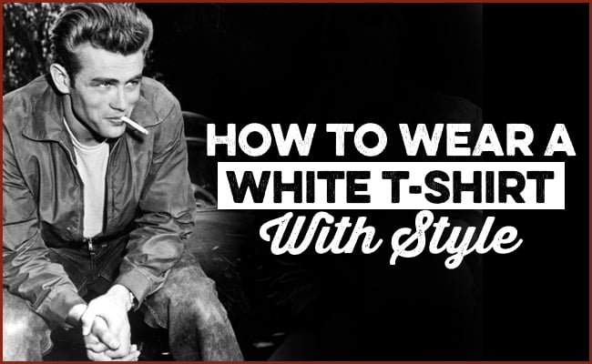 A man in a white t-shirt and jacket sits outdoors, smoking, with the text "How to Wear a White T-Shirt With Style" overlaid, showing you how to wear this classic piece with effortless style.