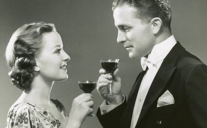 wine Vintage couple holding glasses of drink and looking at each other.