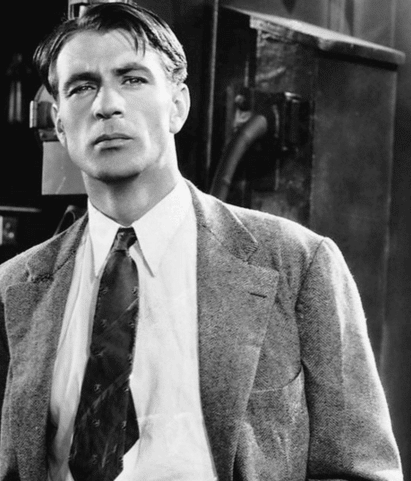 A black and white photo of a man in a suit showcasing poise.